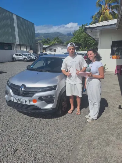 Jeune couple au départ avec une Renault Kwid grise